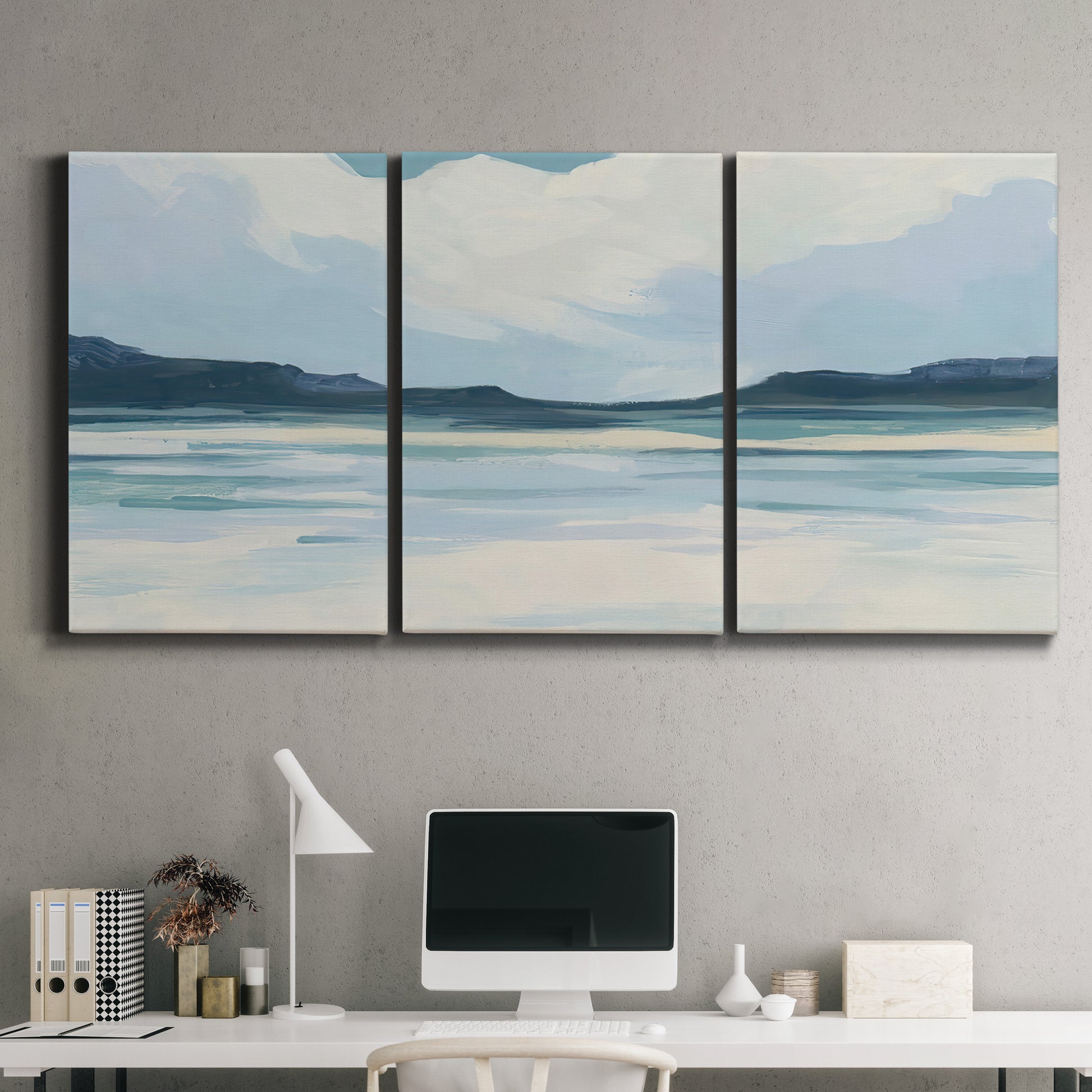 Three-panel canvas wall art featuring soft coastal shoreline landscape, displayed above a desk in a home office.