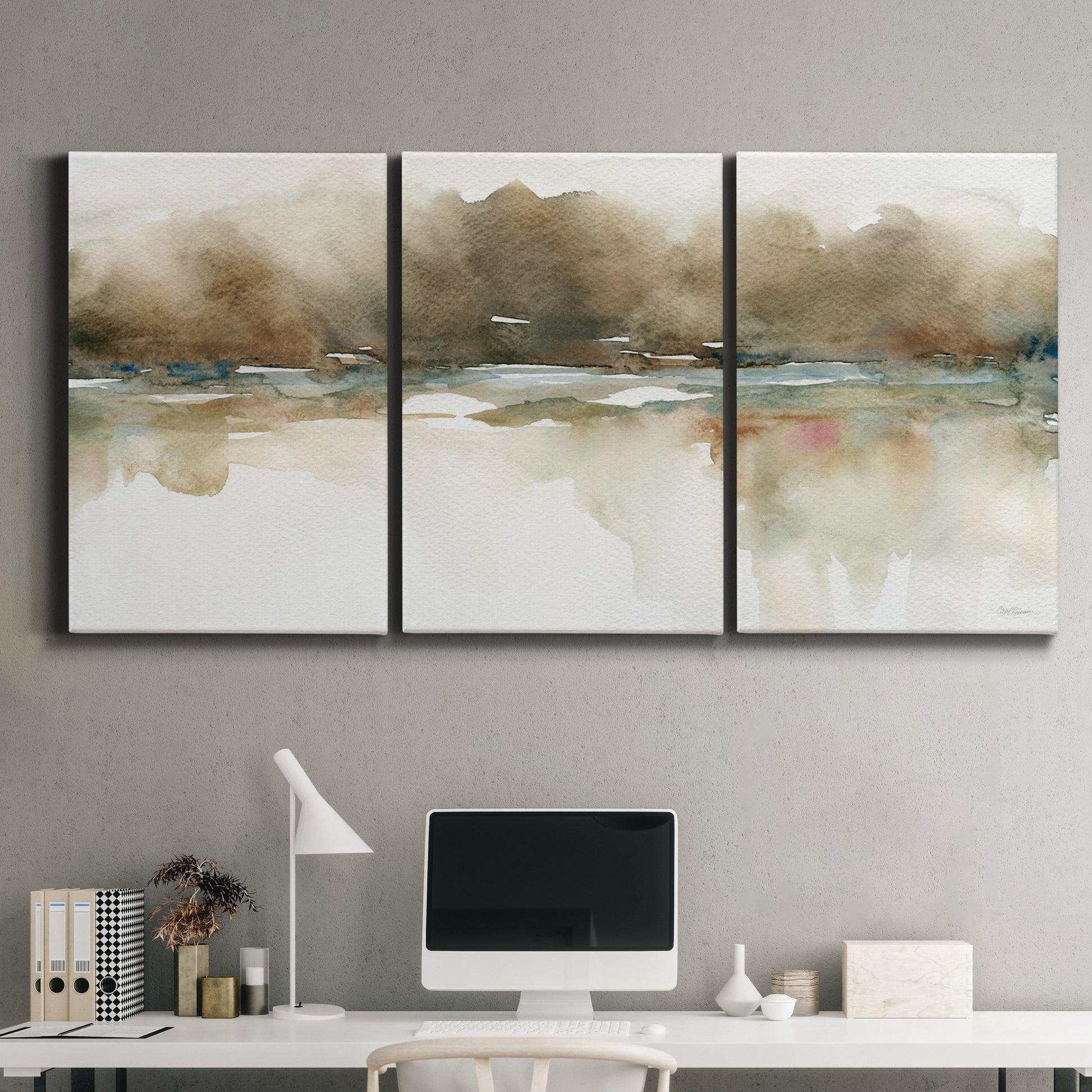 Three-panel canvas wall art featuring soft abstract mirrored reflections, displayed above a desk in a home office.