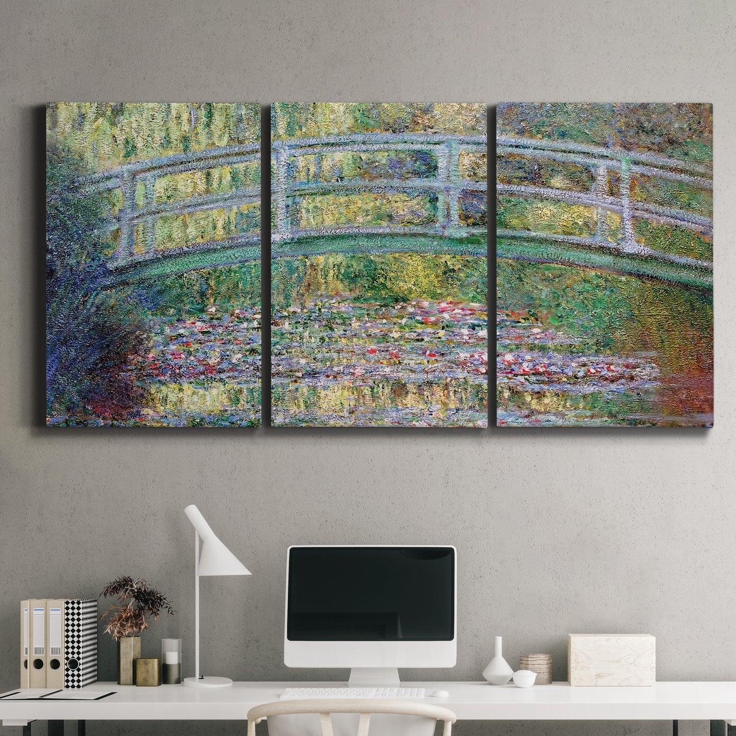 Three-panel canvas wall art featuring water lilies with arched bridge, displayed above a desk in a home office.