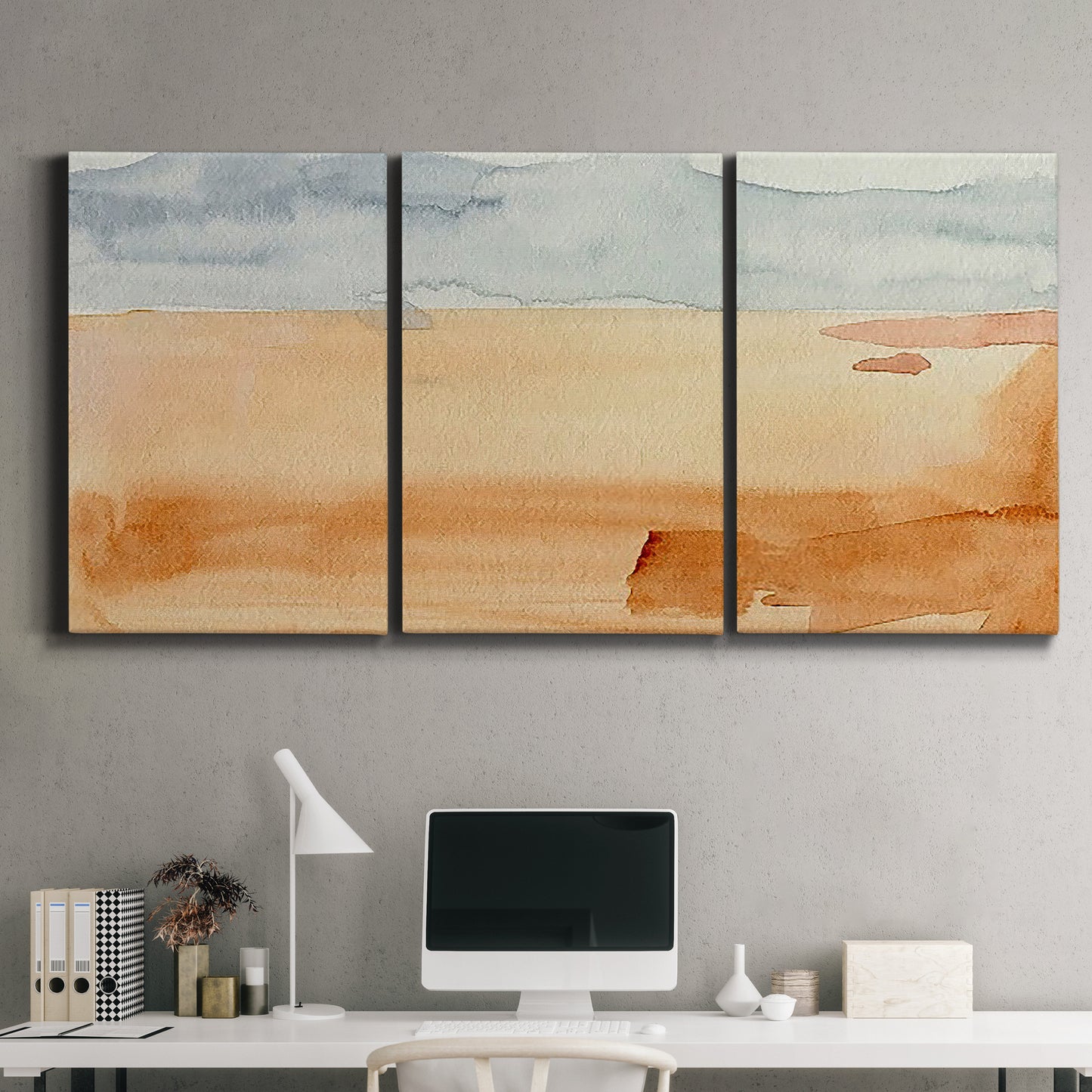 Three-panel canvas wall art featuring minimal horizon with soft blue tones, displayed above a desk in a home office.