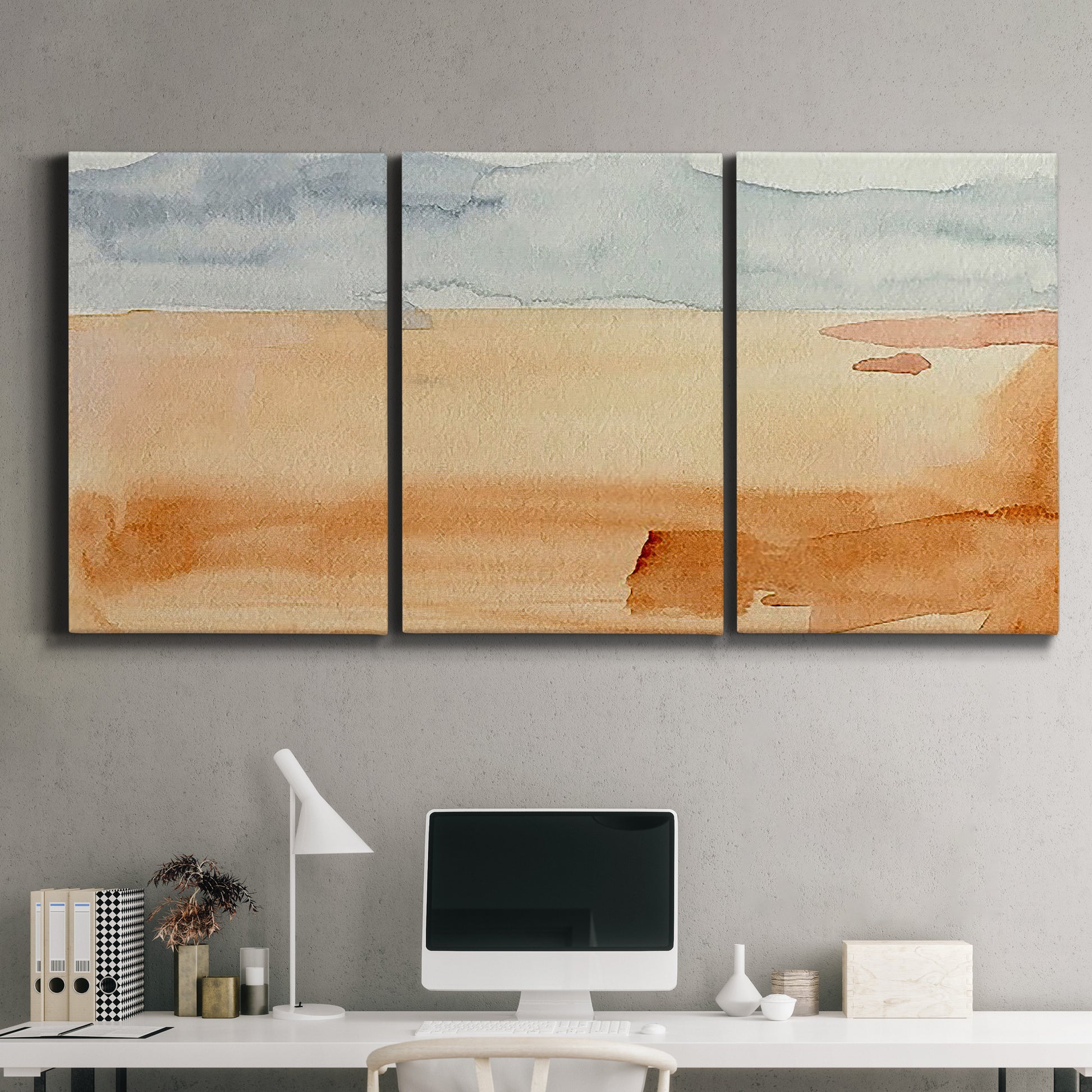 Three-panel canvas wall art featuring minimal horizon with soft blue tones, displayed above a desk in a home office.