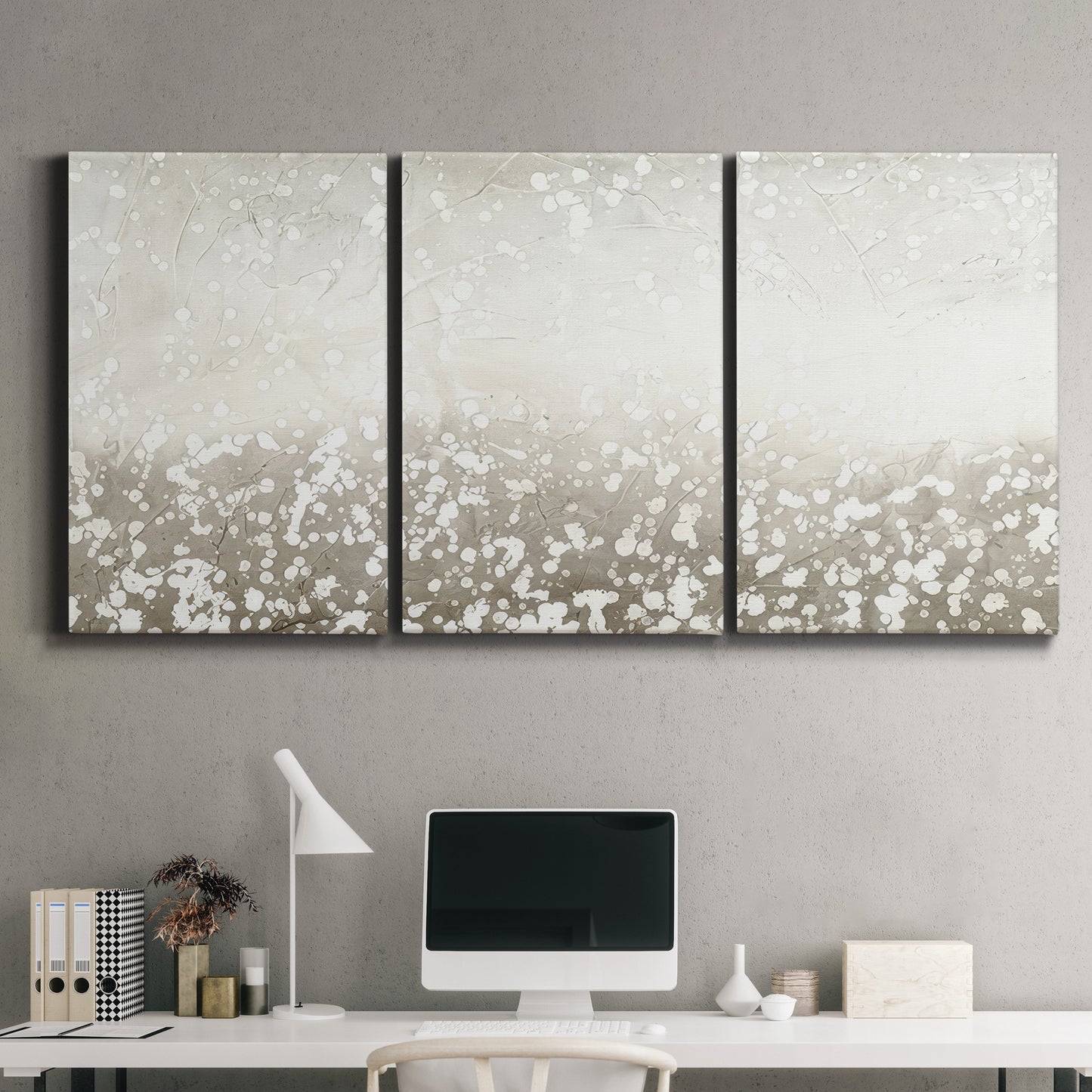 Three-panel canvas wall art featuring dark textured abstract mist, displayed above a desk in a home office.