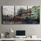 Three-panel canvas wall art featuring riverside town dike at evening, displayed above a desk in a home office.