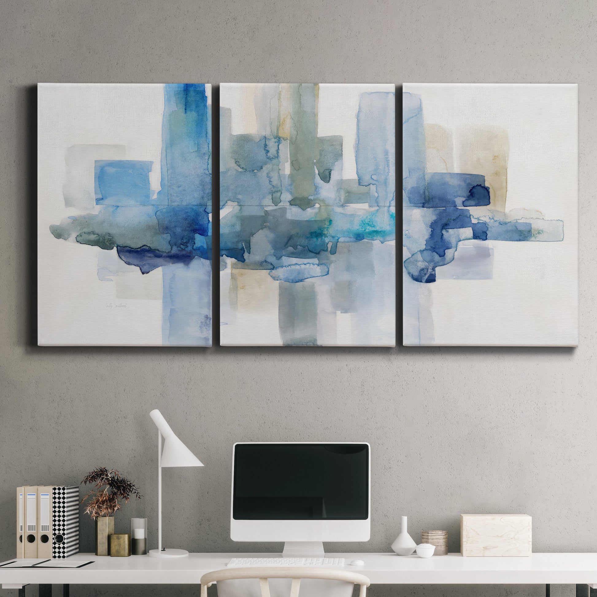 Three-panel canvas wall art featuring minimal urban skyline watercolor, displayed above a desk in a home office.
