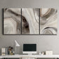 Three-panel canvas wall art featuring layered stone inspired abstract forms, displayed above a desk in a home office.