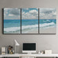 Three-panel canvas wall art featuring tropical beach scene with turquoise water, displayed above a desk in a home office.