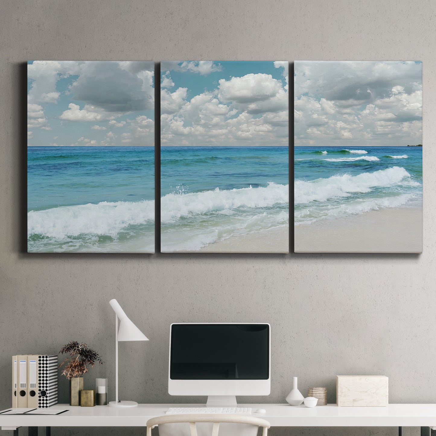 Three-panel canvas wall art featuring tropical beach scene with turquoise water, displayed above a desk in a home office.