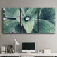 Three-panel canvas wall art featuring green succulent plant photograph, displayed above a desk in a home office.