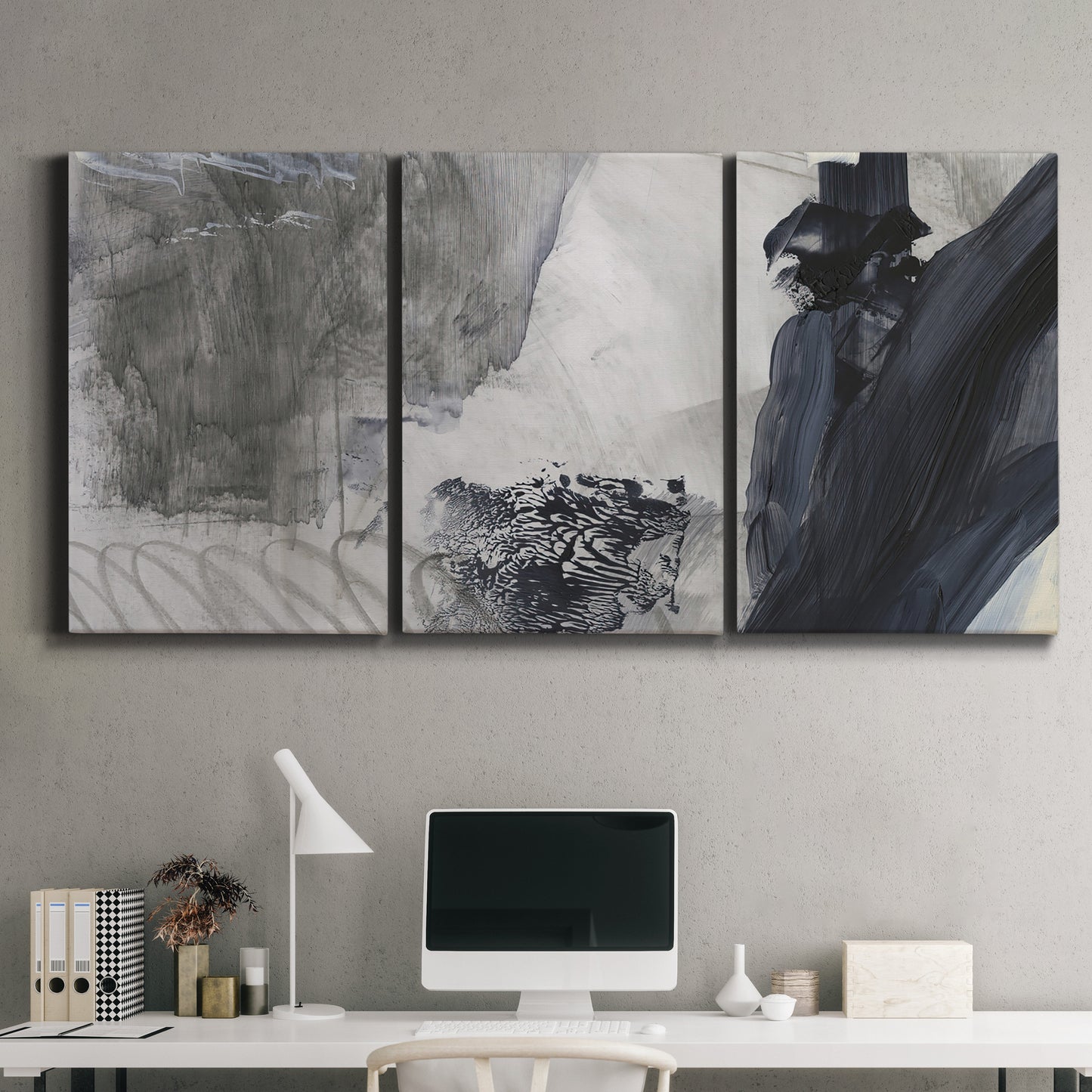Three-panel canvas wall art featuring dark abstract atmospheric landscape, displayed above a desk in a home office.