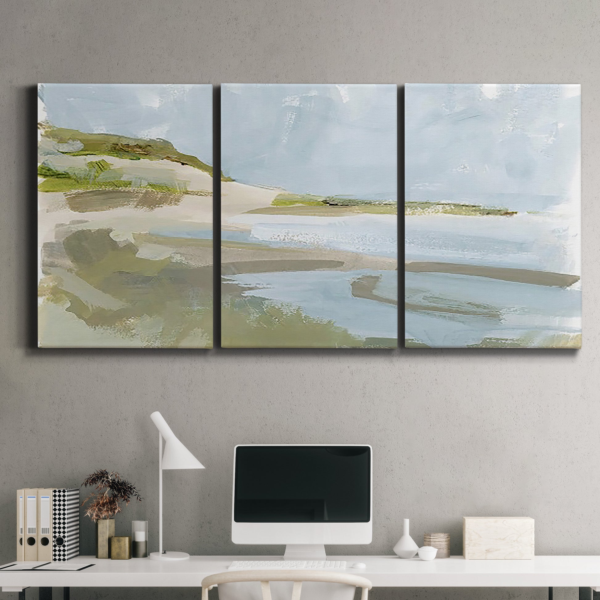 Three-panel canvas wall art featuring coastal cove with calm water, displayed above a desk in a home office.