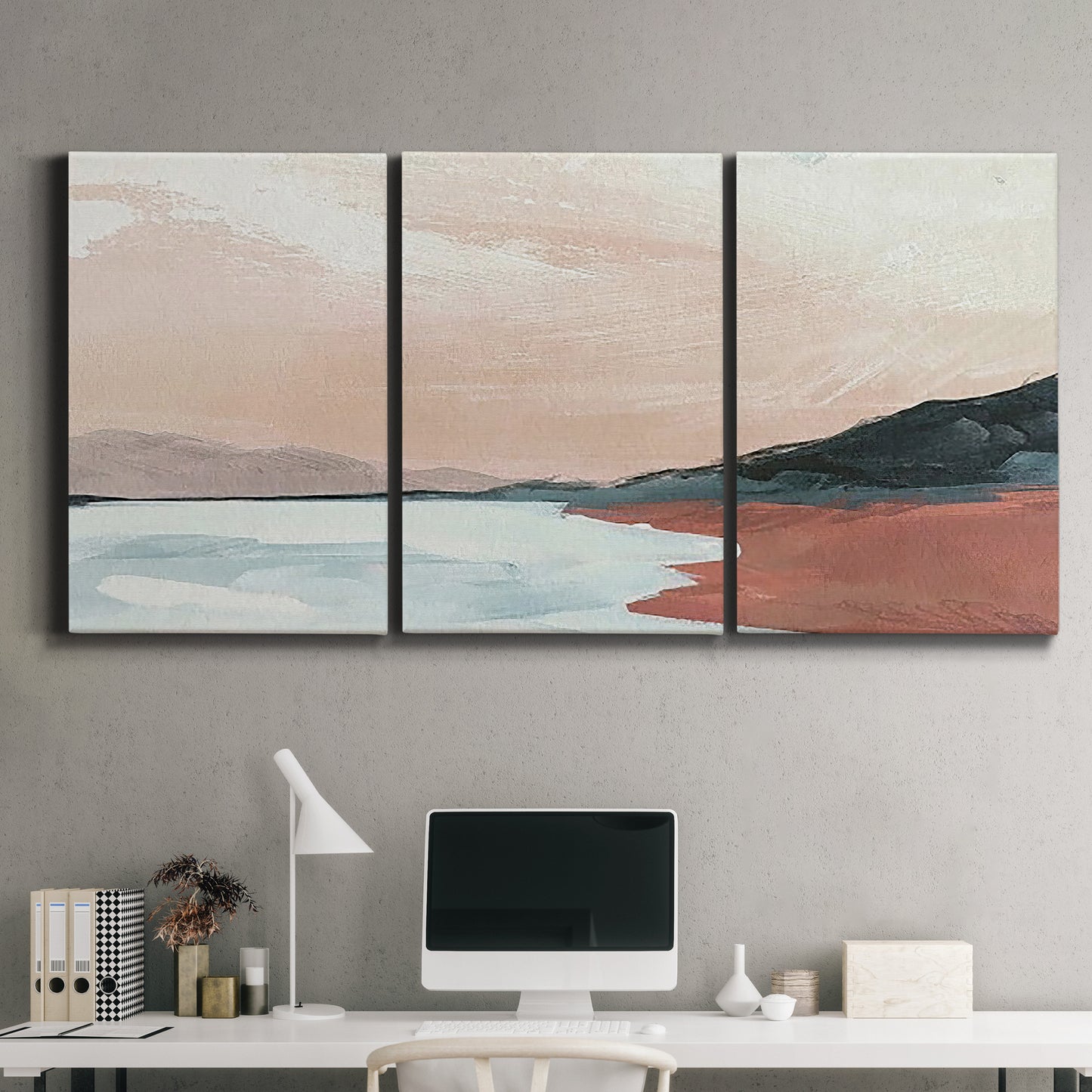 Three-panel canvas wall art featuring quiet coastline with distant horizon, displayed above a desk in a home office.