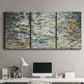 Three-panel canvas wall art featuring abstract water surface reflections, displayed above a desk in a home office.