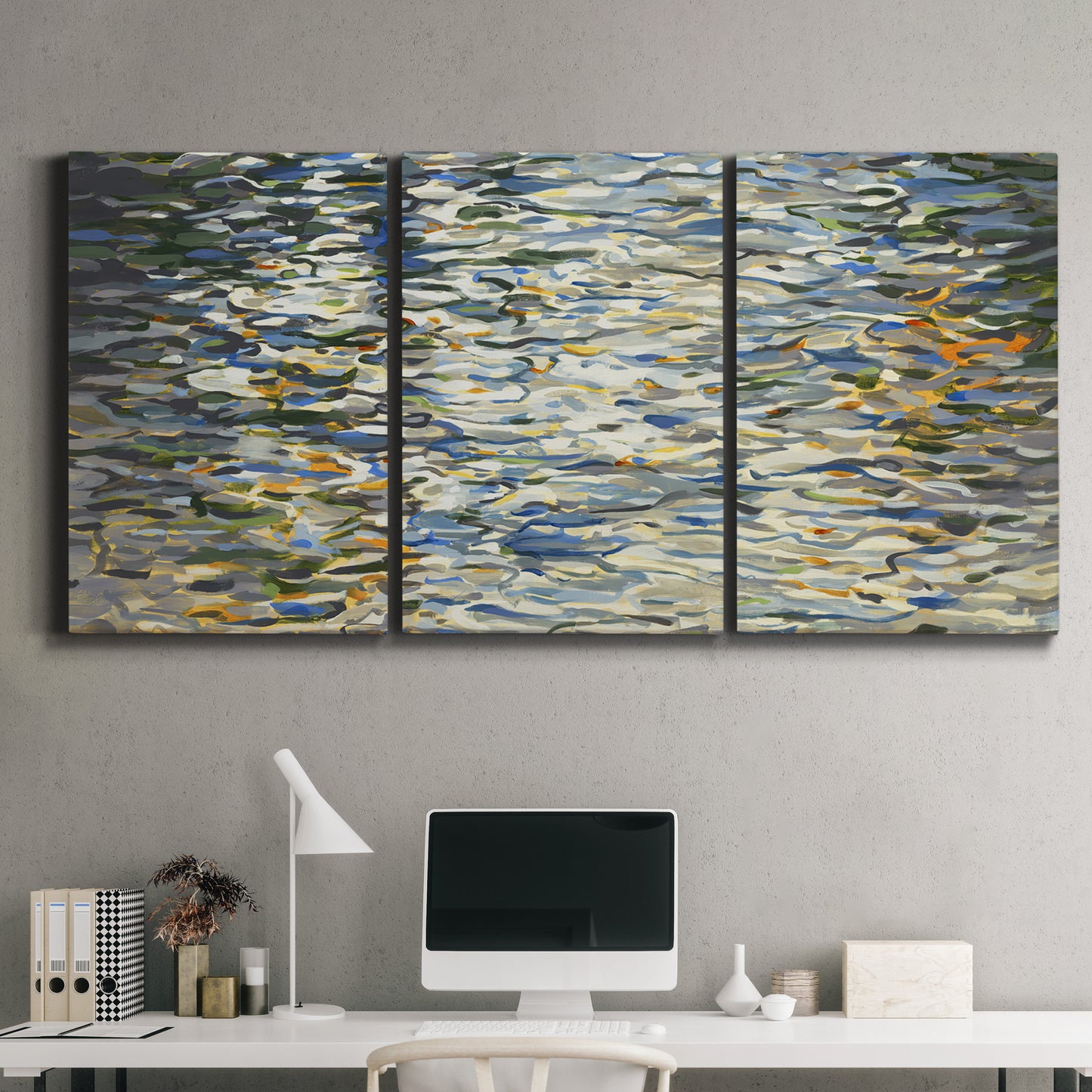 Three-panel canvas wall art featuring abstract water surface reflections, displayed above a desk in a home office.