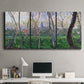 Three-panel canvas wall art featuring spring landscape along river, displayed above a desk in a home office.