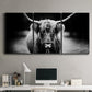 Three-panel canvas wall art featuring black and white cattle portrait, displayed above a desk in a home office.