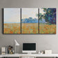 Three-panel canvas wall art featuring oat field with scattered poppies, displayed above a desk in a home office.