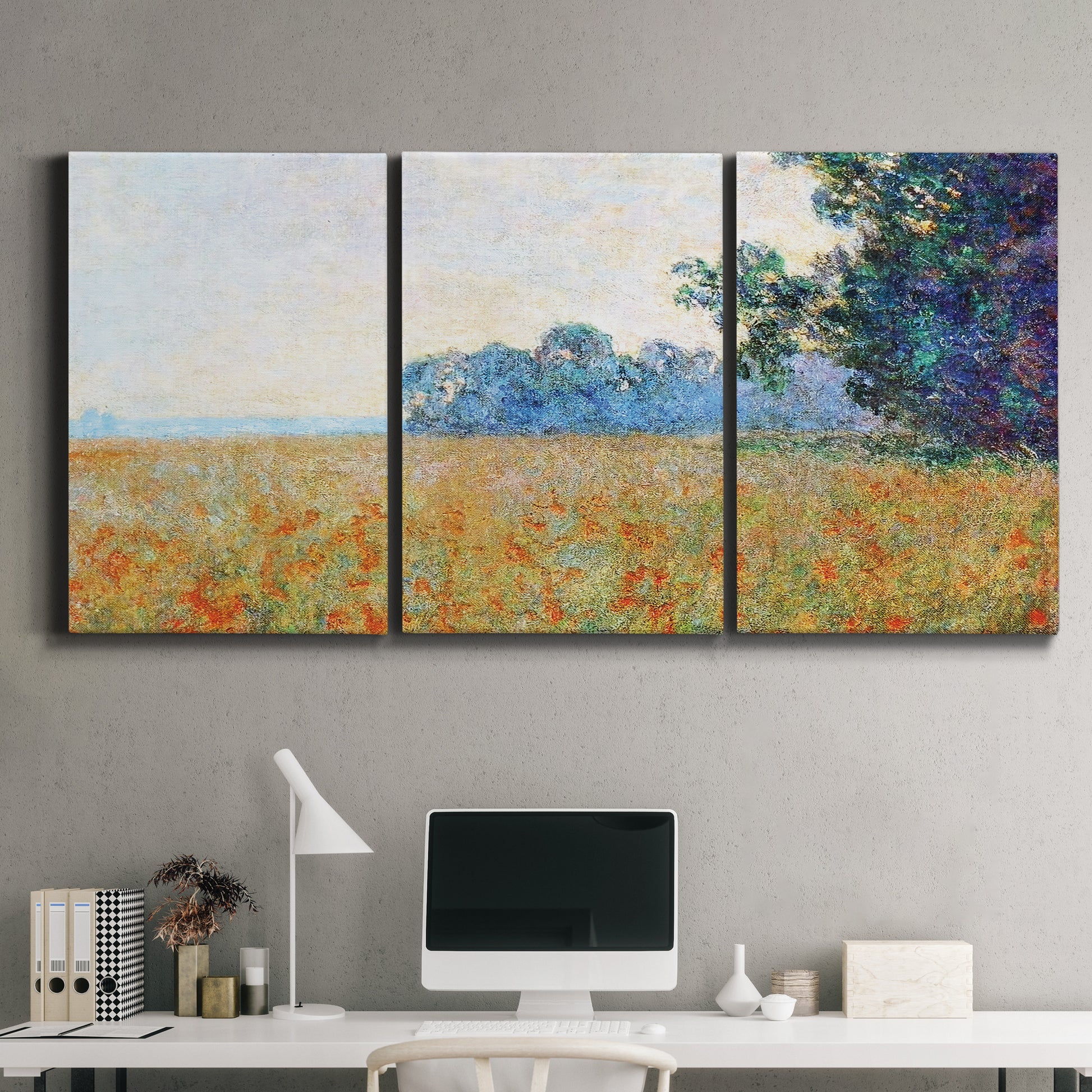 Three-panel canvas wall art featuring oat field with scattered poppies, displayed above a desk in a home office.