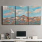 Three-panel canvas wall art featuring soft pastel western hills landscape, displayed above a desk in a home office.