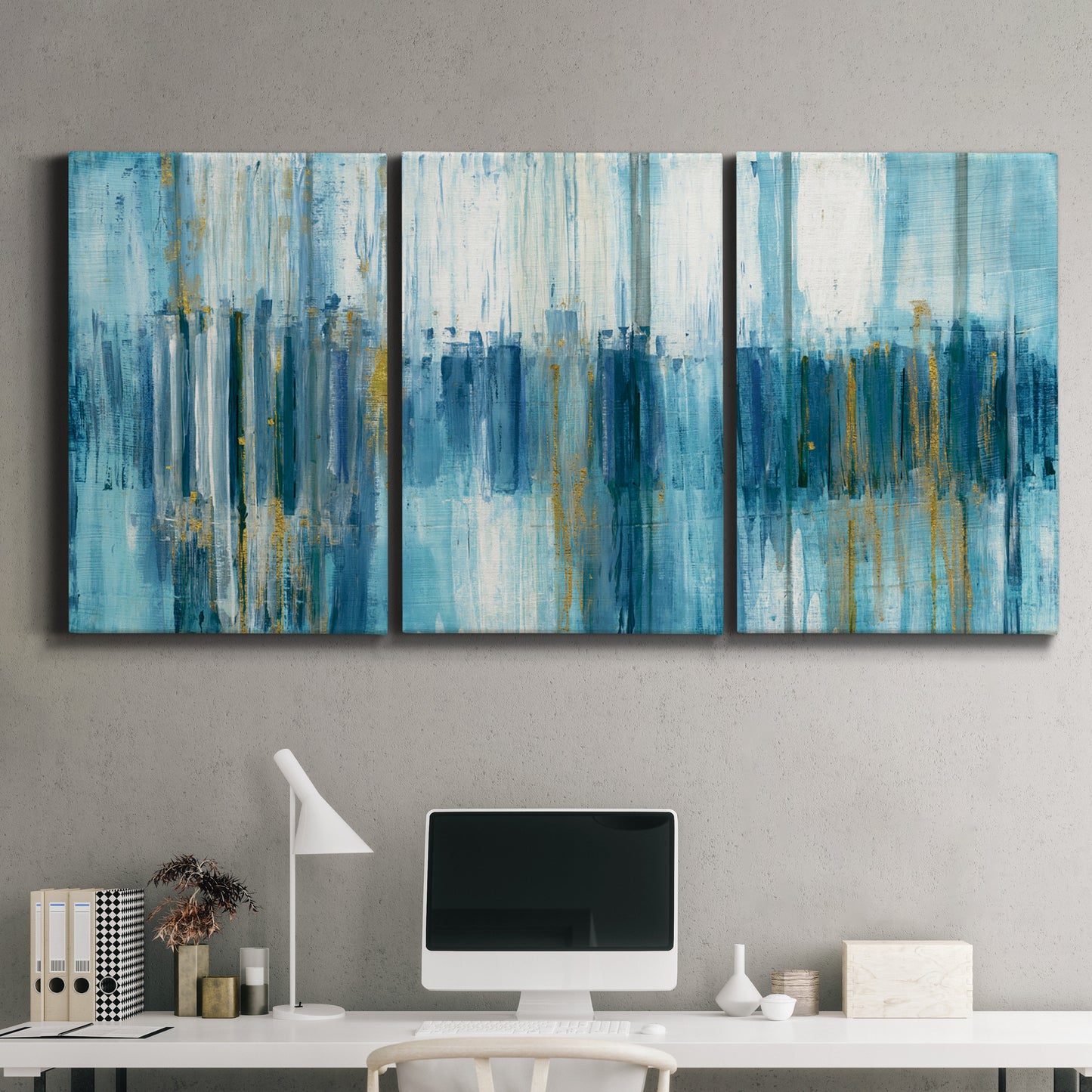 Three-panel canvas wall art featuring layered abstract earth tones, displayed above a desk in a home office.