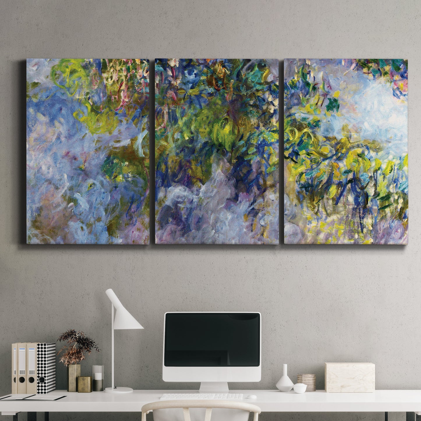 Three-panel canvas wall art featuring cascading purple wisteria blooms, displayed above a desk in a home office.