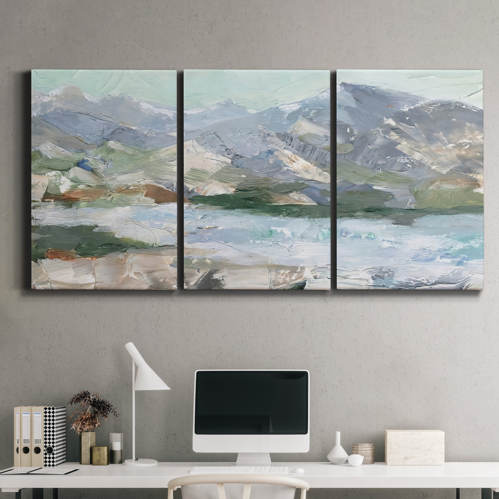 Three-panel canvas wall art featuring pastel mountain landscape view, displayed above a desk in a home office.