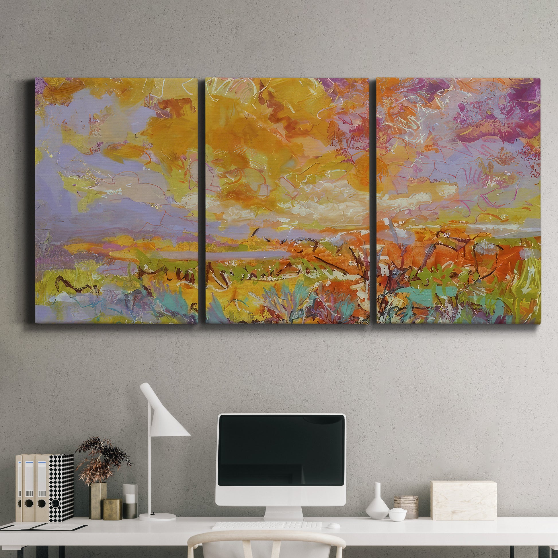 Three-panel canvas wall art featuring abstract meadow inspired color fields, displayed above a desk in a home office.