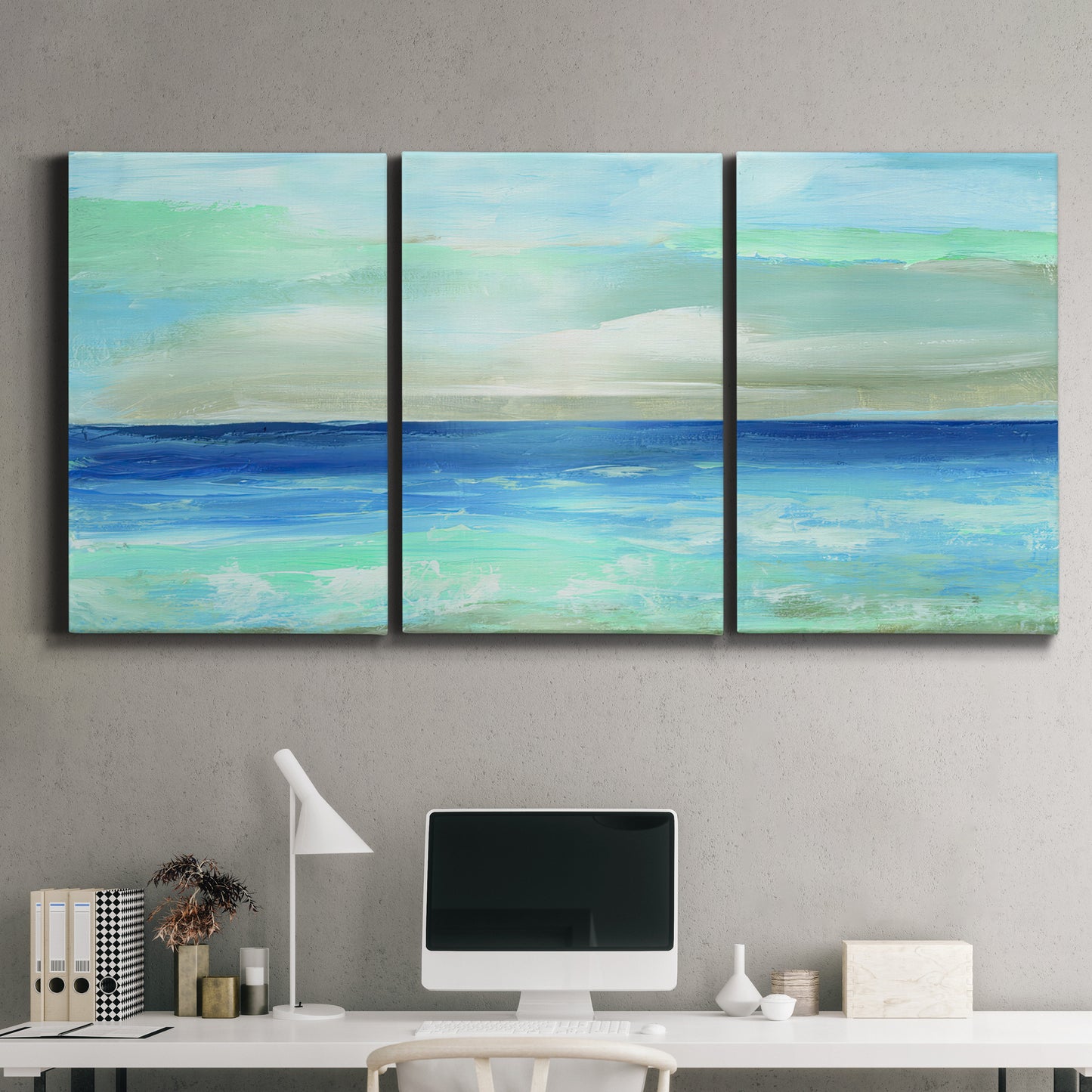 Three-panel canvas wall art featuring vast open blue ocean horizon, displayed above a desk in a home office.