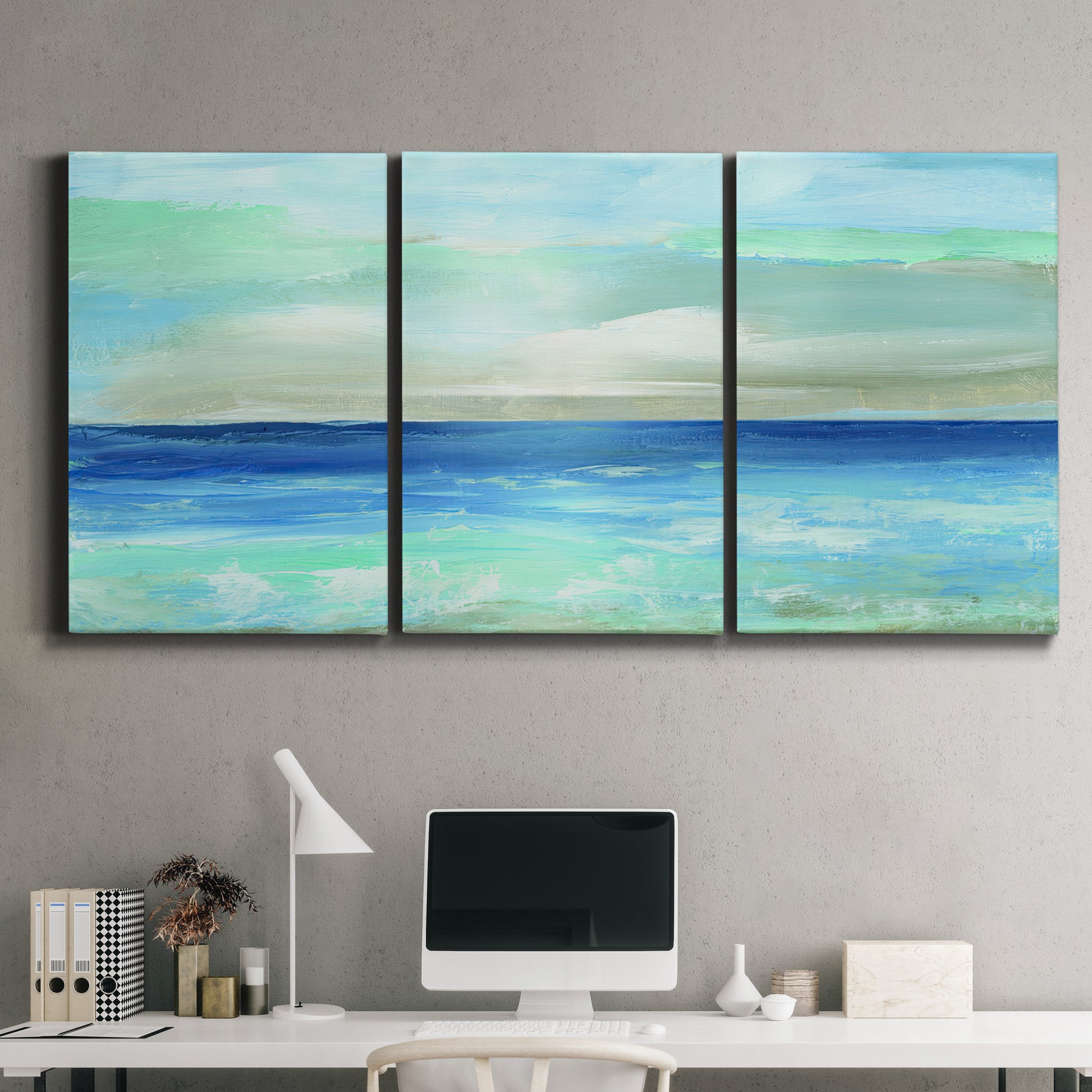 Three-panel canvas wall art featuring vast open blue ocean horizon, displayed above a desk in a home office.