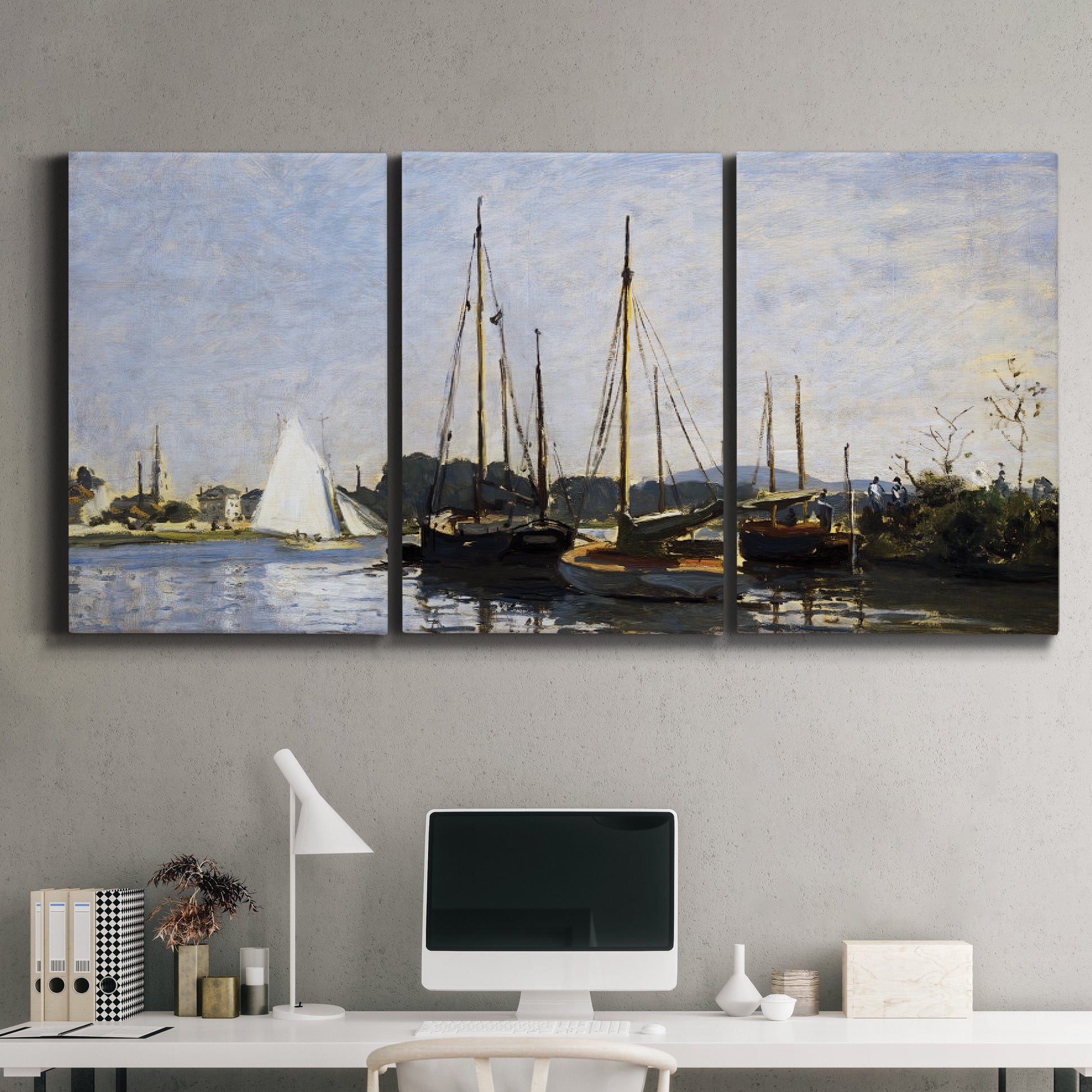 Three-panel canvas wall art featuring small pleasure boats on calm water, displayed above a desk in a home office.