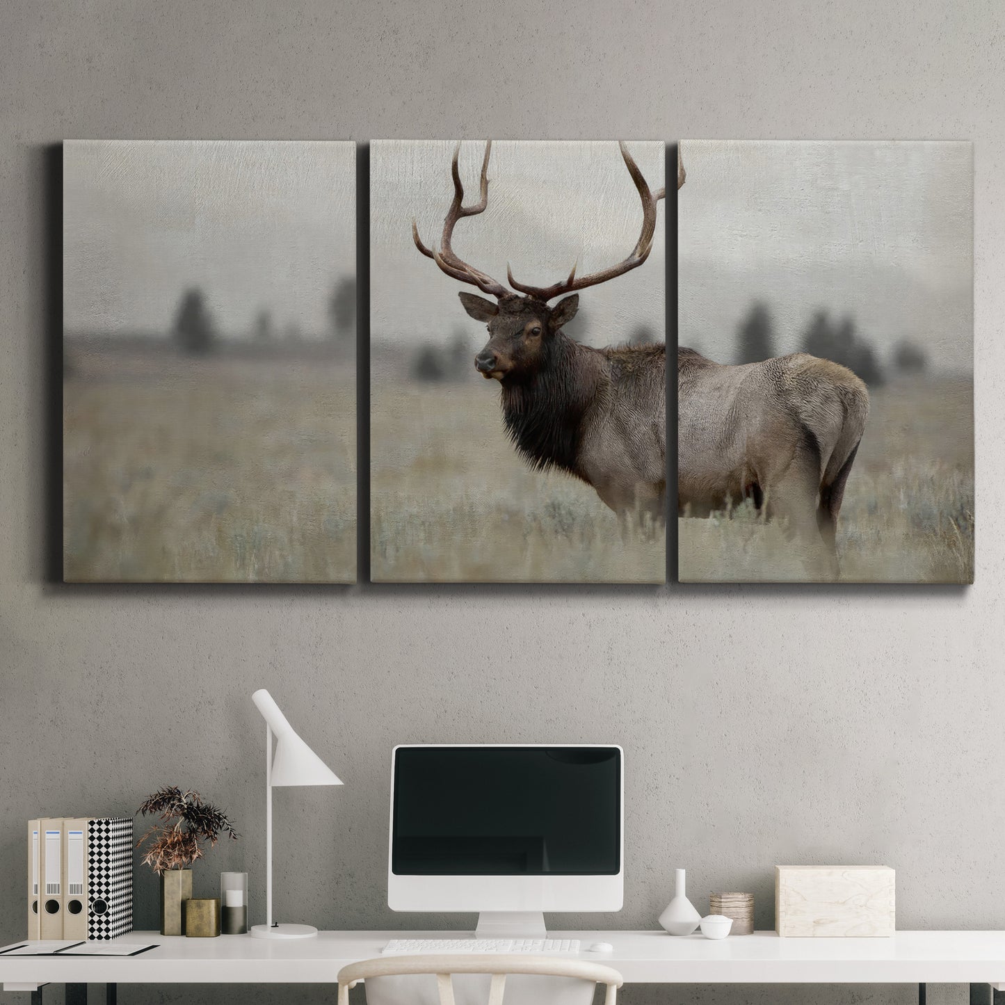 Three-panel canvas wall art featuring elk standing in open grassland, displayed above a desk in a home office.