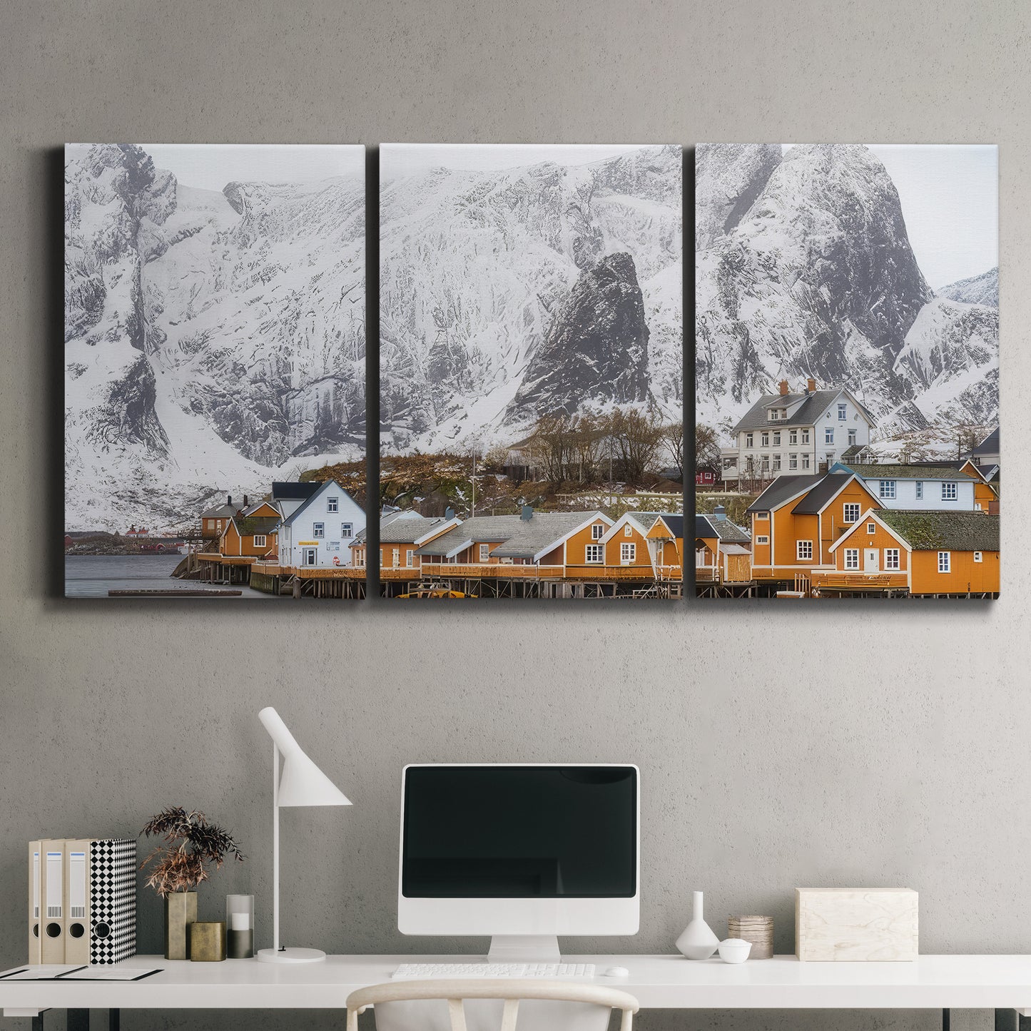 Three-panel canvas wall art featuring winter village street photography, displayed above a desk in a home office.
