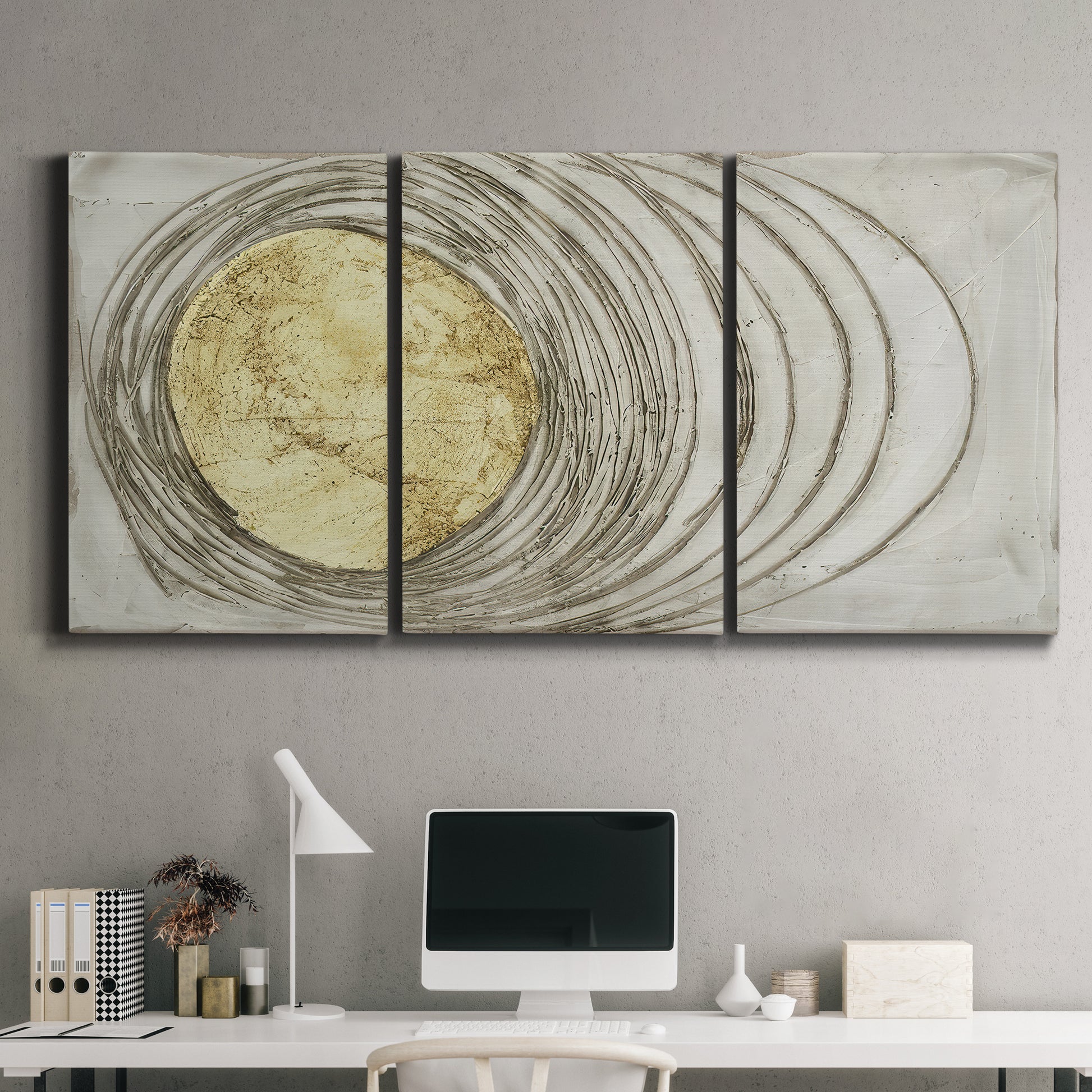 Three-panel canvas wall art featuring circular abstract energy forms, displayed above a desk in a home office.