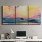 Three-panel canvas wall art featuring prismatic watercolor coastal seascape, displayed above a desk in a home office.