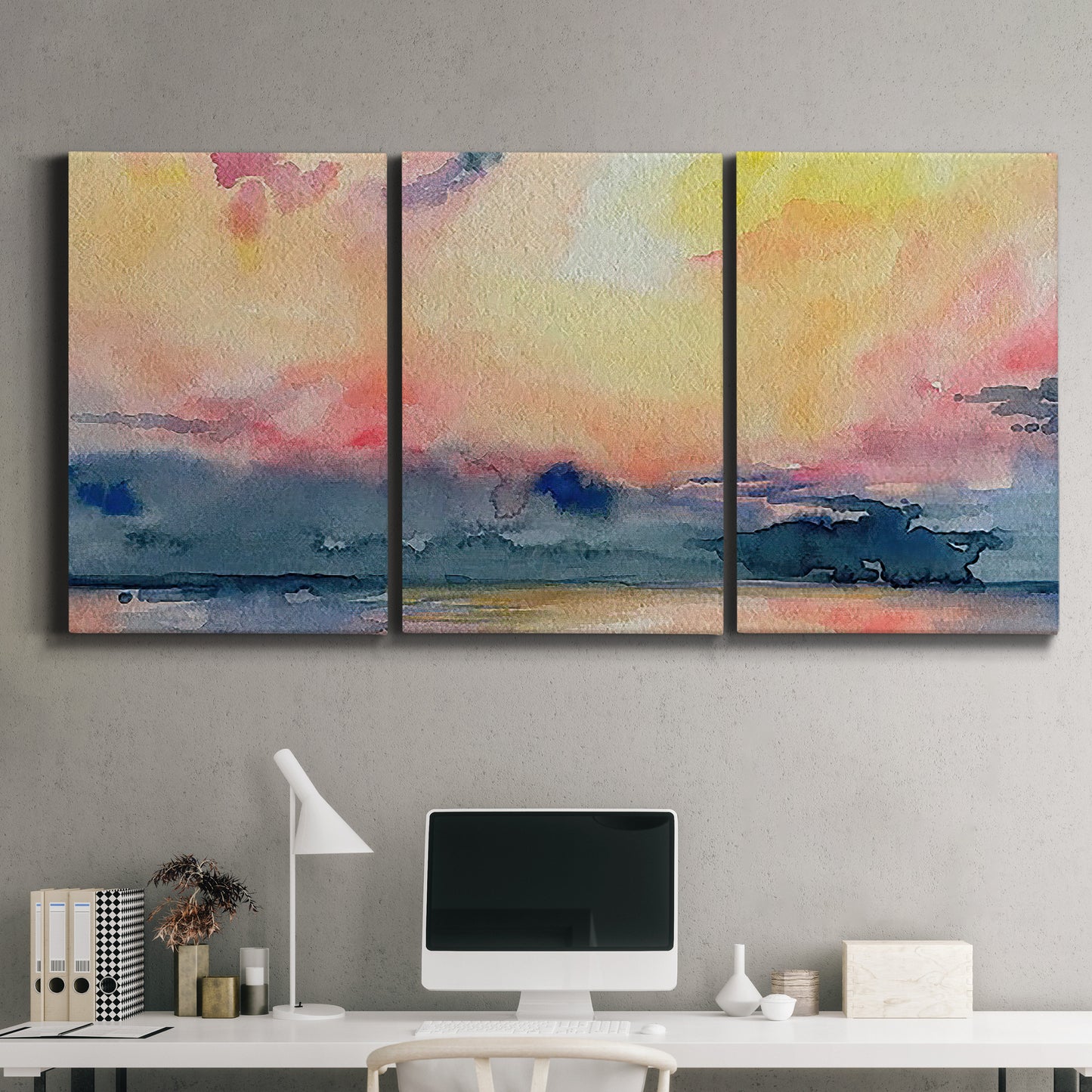 Three-panel canvas wall art featuring prismatic watercolor coastal seascape, displayed above a desk in a home office.