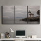 Three-panel canvas wall art featuring lighthouse watching over coastline, displayed above a desk in a home office.