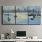 Three-panel canvas wall art featuring anchored boats near shoreline, displayed above a desk in a home office.