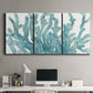 Three-panel canvas wall art featuring blue coral inspired watercolor, displayed above a desk in a home office.