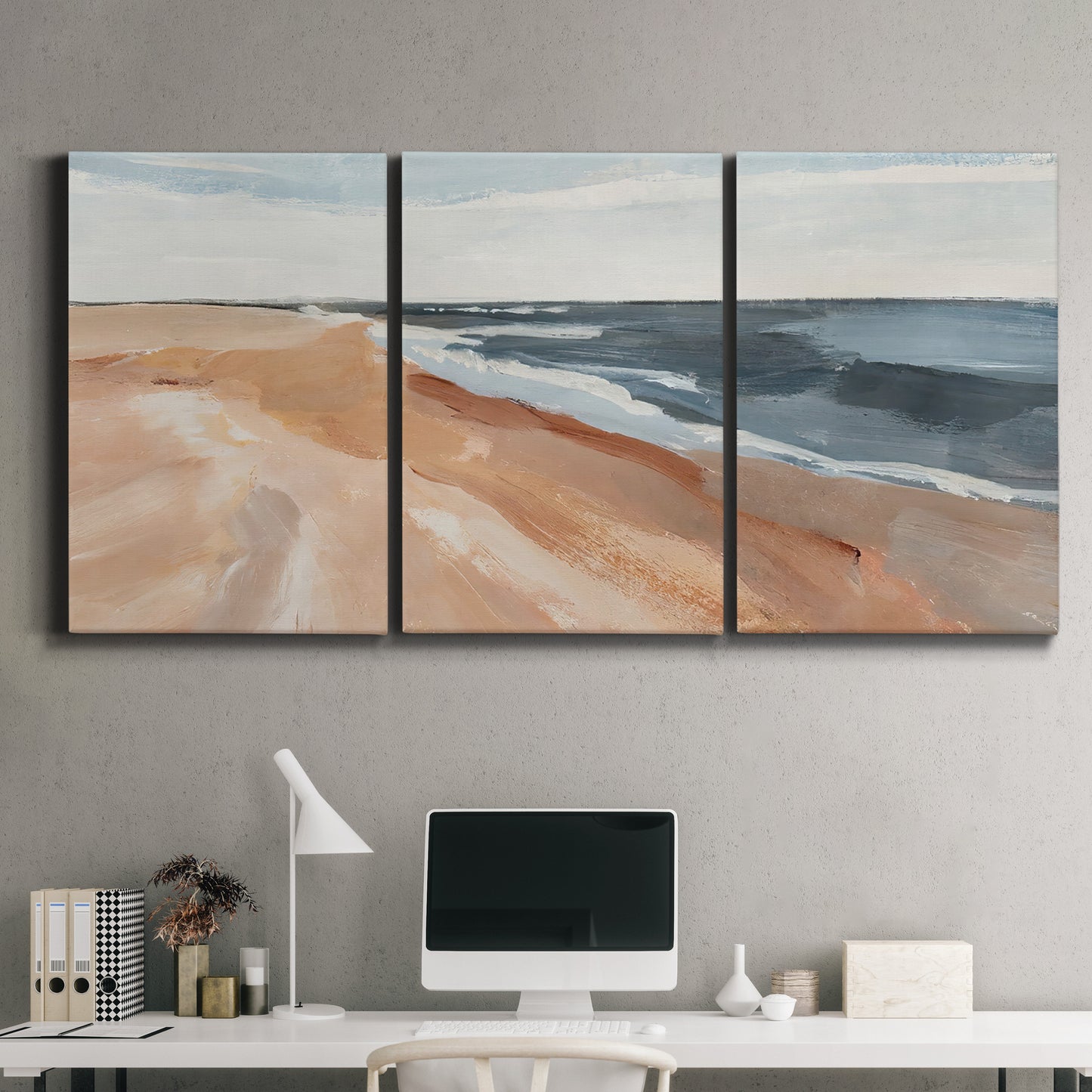 Three-panel canvas wall art featuring abstract coastal beach composition, displayed above a desk in a home office.