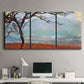 Three-panel canvas wall art featuring coastal trees at evening light, displayed above a desk in a home office.