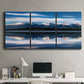 Three-panel canvas wall art featuring calm lake beneath mountains photograph, displayed above a desk in a home office.