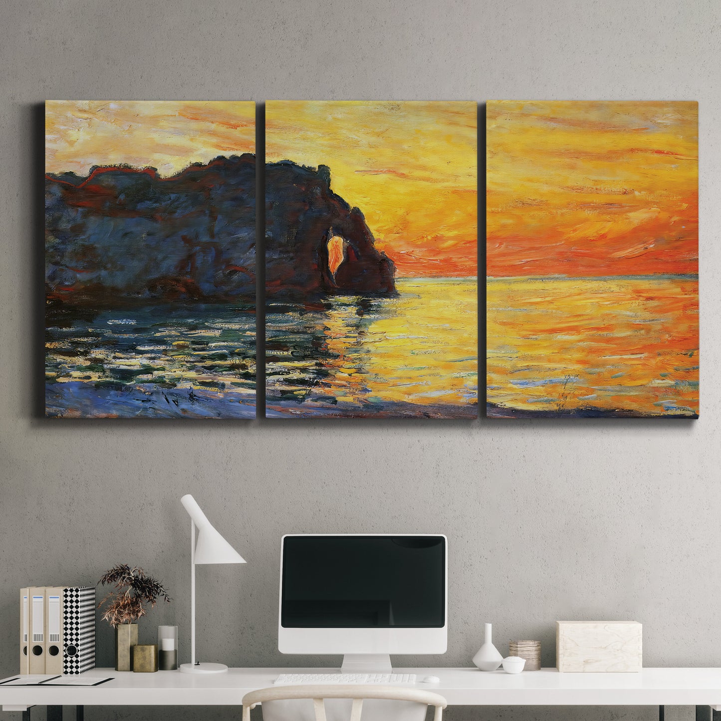 Three-panel canvas wall art featuring arched coastal cliff above sea, displayed above a desk in a home office.