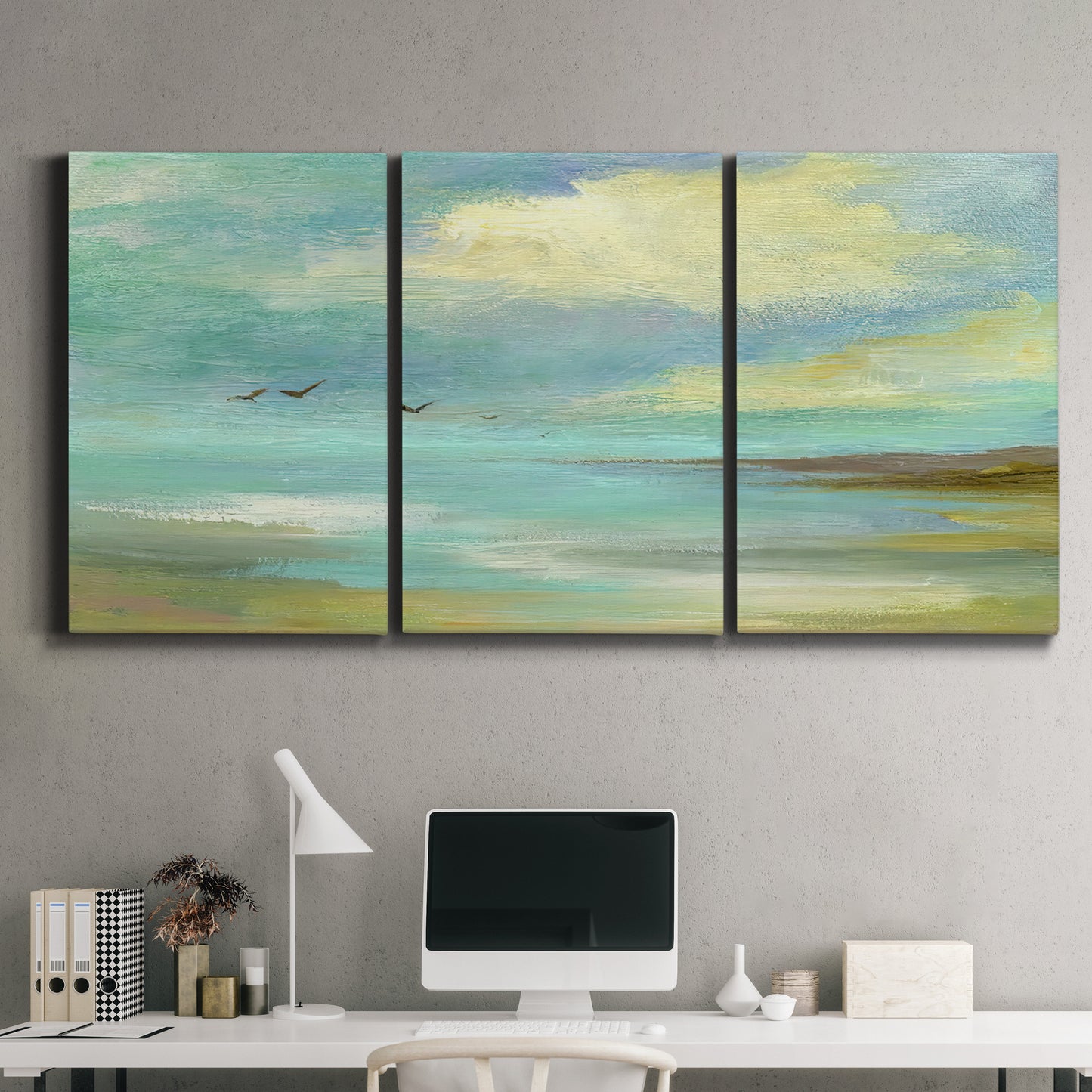 Three-panel canvas wall art featuring calm coastal drift patterns, displayed above a desk in a home office.
