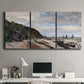 Three-panel canvas wall art featuring open sea along rocky shore, displayed above a desk in a home office.