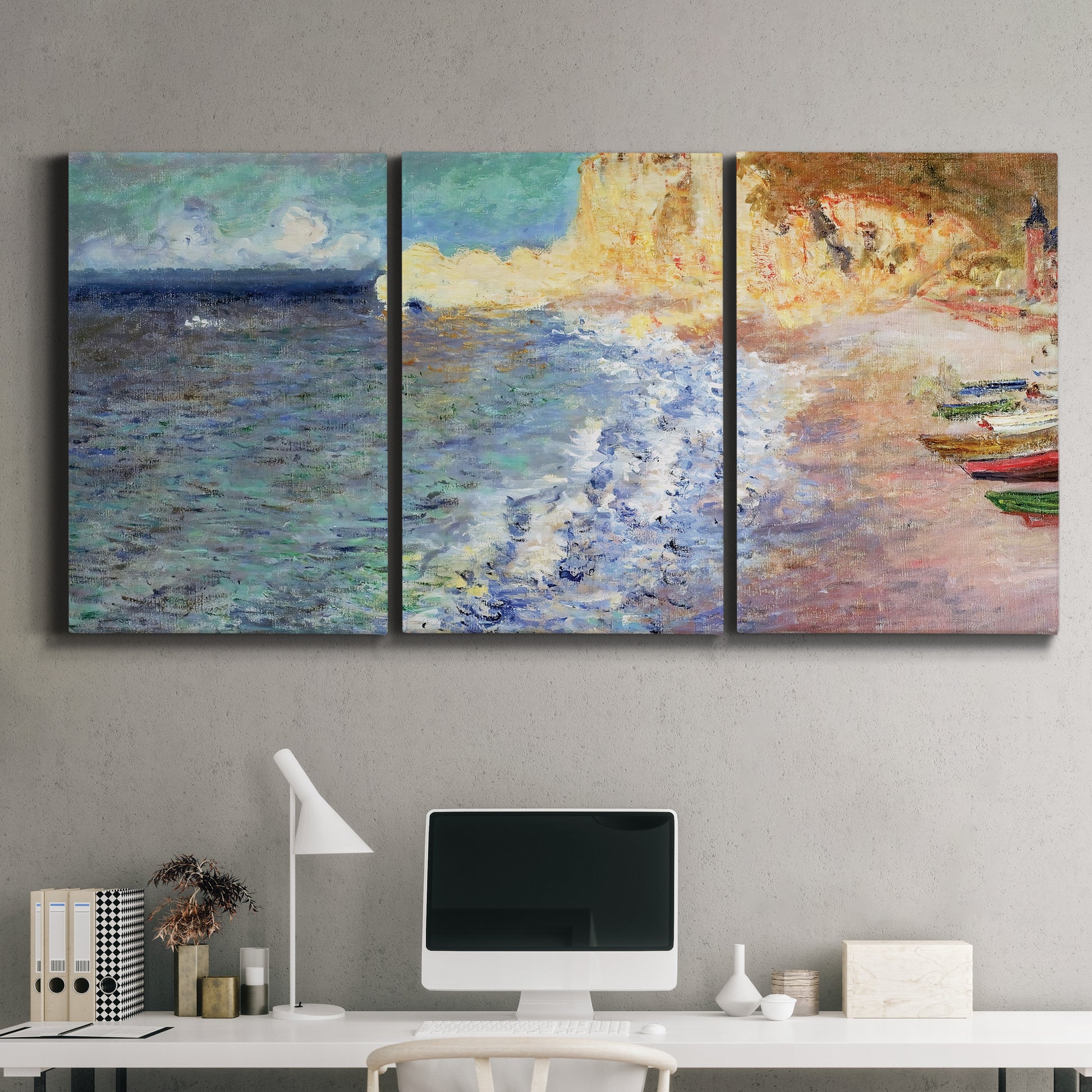 Three-panel canvas wall art featuring figures along rocky beach, displayed above a desk in a home office.