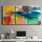 Three-panel canvas wall art featuring layered abstract observational color blocks, displayed above a desk in a home office.