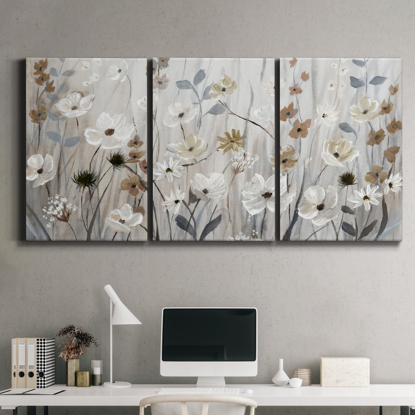 Three-panel canvas wall art featuring misty wildflower meadow landscape, displayed above a desk in a home office.