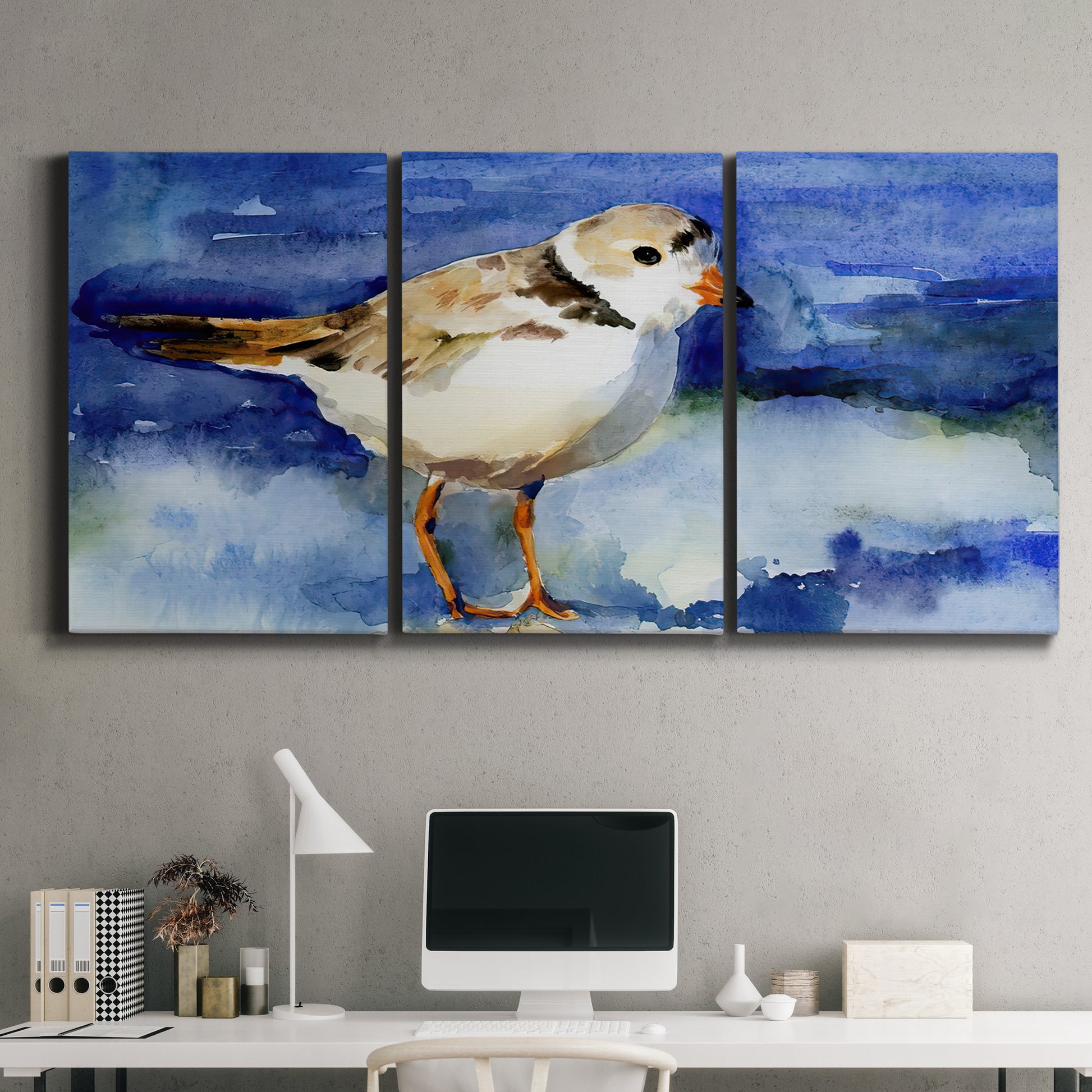 Three-panel canvas wall art featuring shorebirds standing in shallow water, displayed above a desk in a home office.