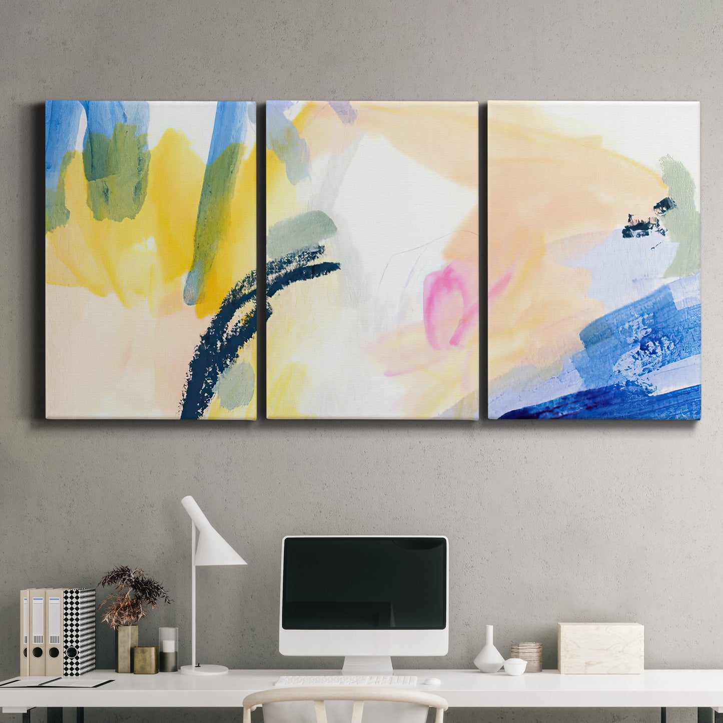 Three-panel canvas wall art featuring bright abstract candy colored strokes, displayed above a desk in a home office.