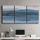 Three-panel canvas wall art featuring wide lake with distant shoreline, displayed above a desk in a home office.