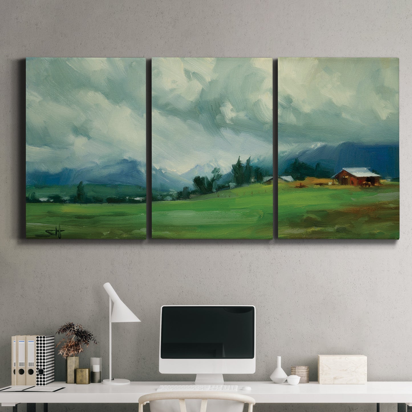 Three-panel canvas wall art featuring wide pastoral valley landscape, displayed above a desk in a home office.